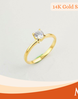 A yellow gold solitaire ring with a round-cut clear gemstone