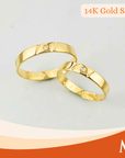 Two gold wedding bands with small round-cut diamonds
