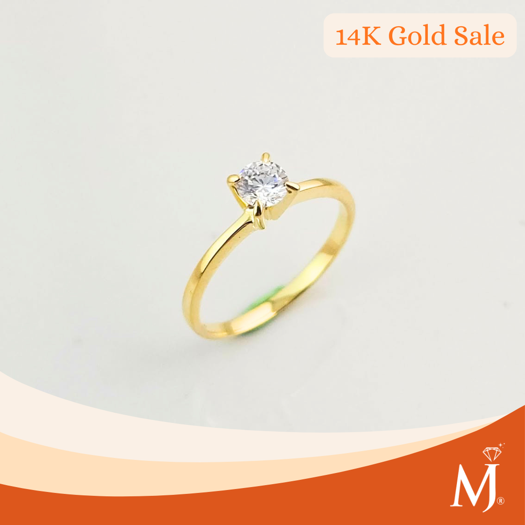 A yellow gold solitaire ring with a round-cut clear gemstone
