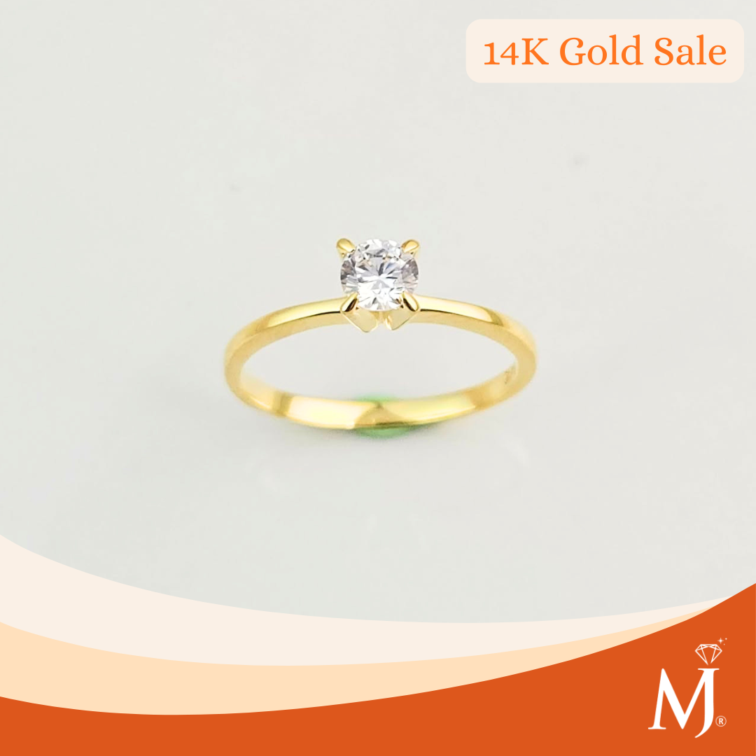 A yellow gold solitaire ring with a round-cut clear gemstone in a four-prong setting