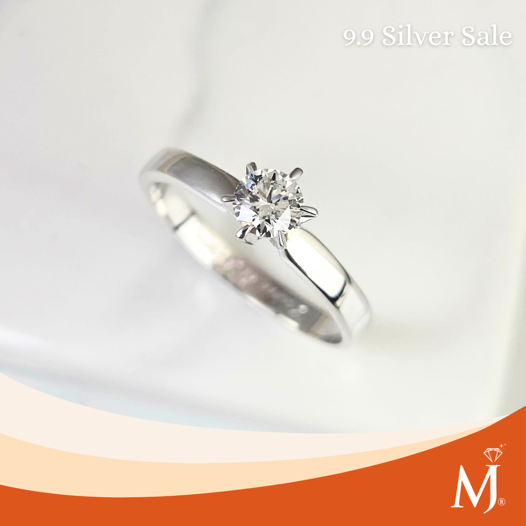 A silver solitaire engagement ring with a round-cut diamond set in a six-prong setting