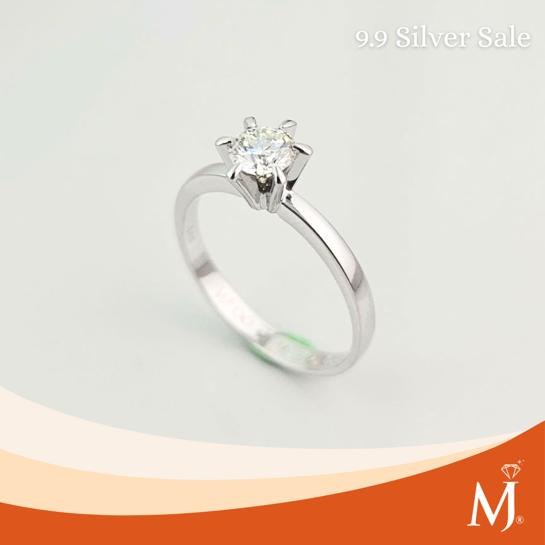 A silver solitaire engagement ring with a round-cut clear gemstone in a six-prong setting