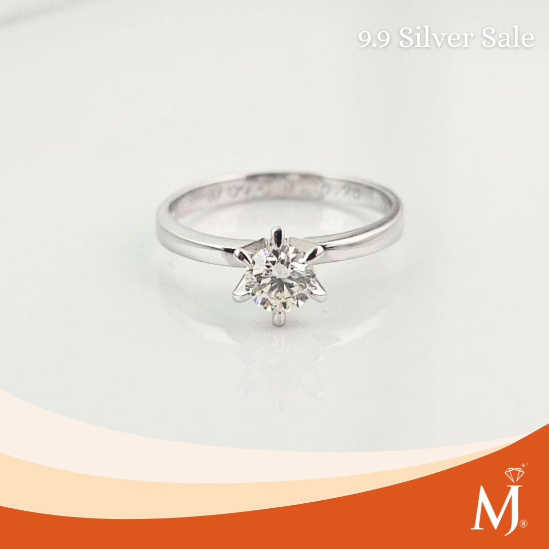 A silver solitaire engagement ring with a round-cut clear gemstone in a prong setting