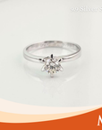 A silver solitaire engagement ring with a round-cut clear gemstone in a prong setting