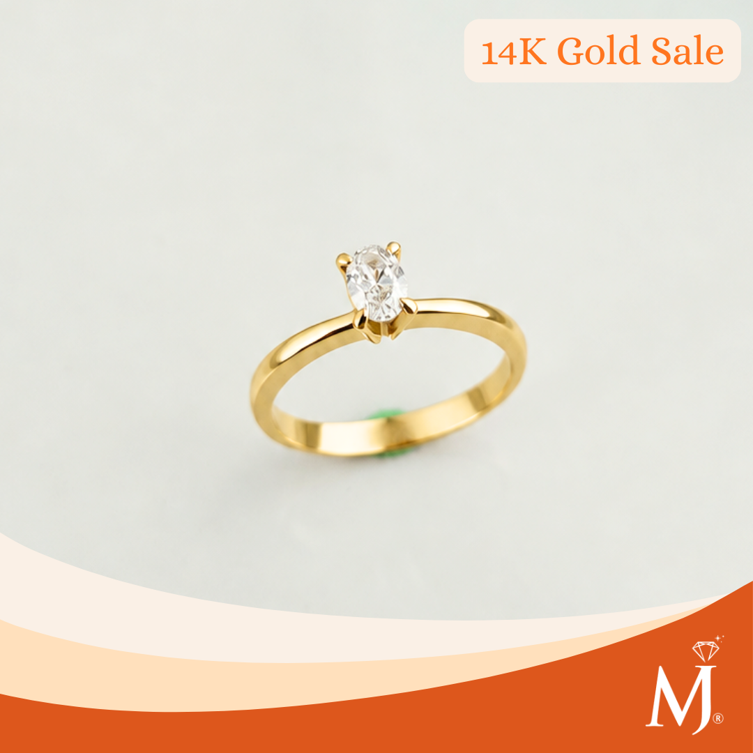 A 14K gold solitaire ring with a oval-cut clear gemstone