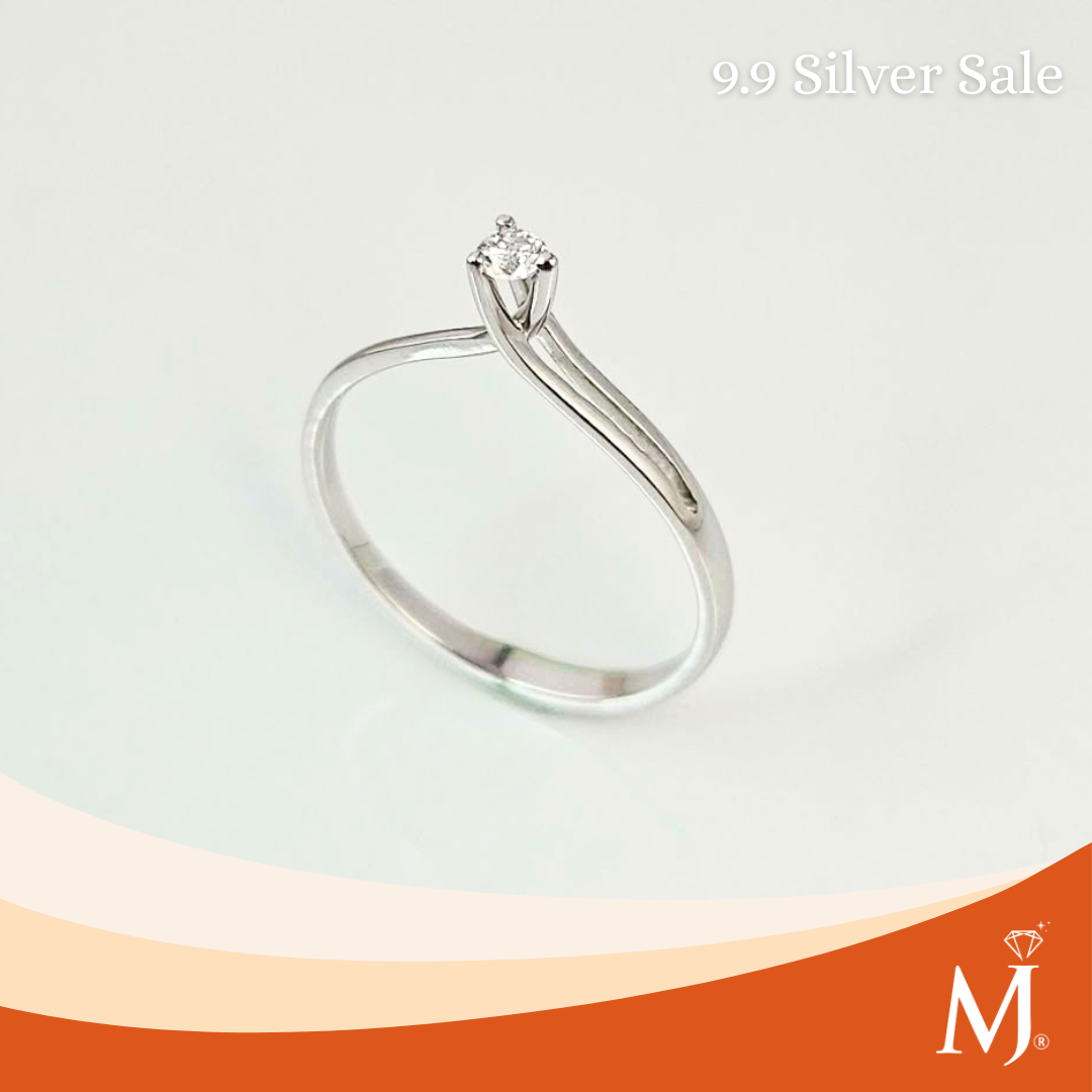 A silver solitaire engagement ring with a round-cut clear gemstone