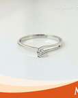 A silver solitaire ring with a round-cut clear gemstone
